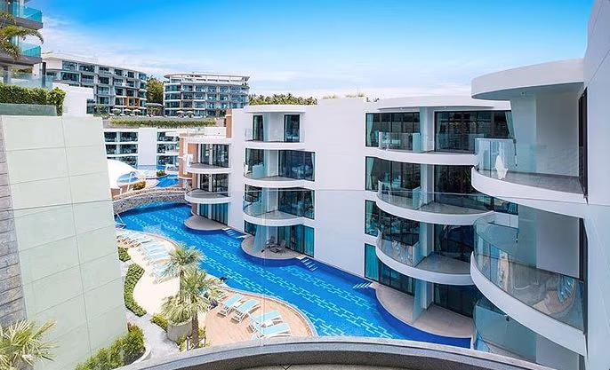 One-bedroom penthouse in Patong with a private pool and seaview overlooking the water. Minimalist patio furniture on the deck faces the ocean.