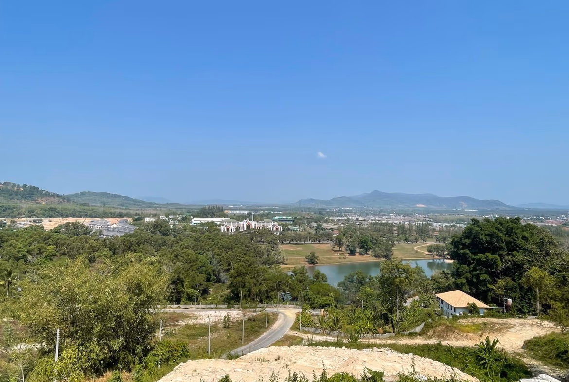 An empty plot of land with sea and mountain views.