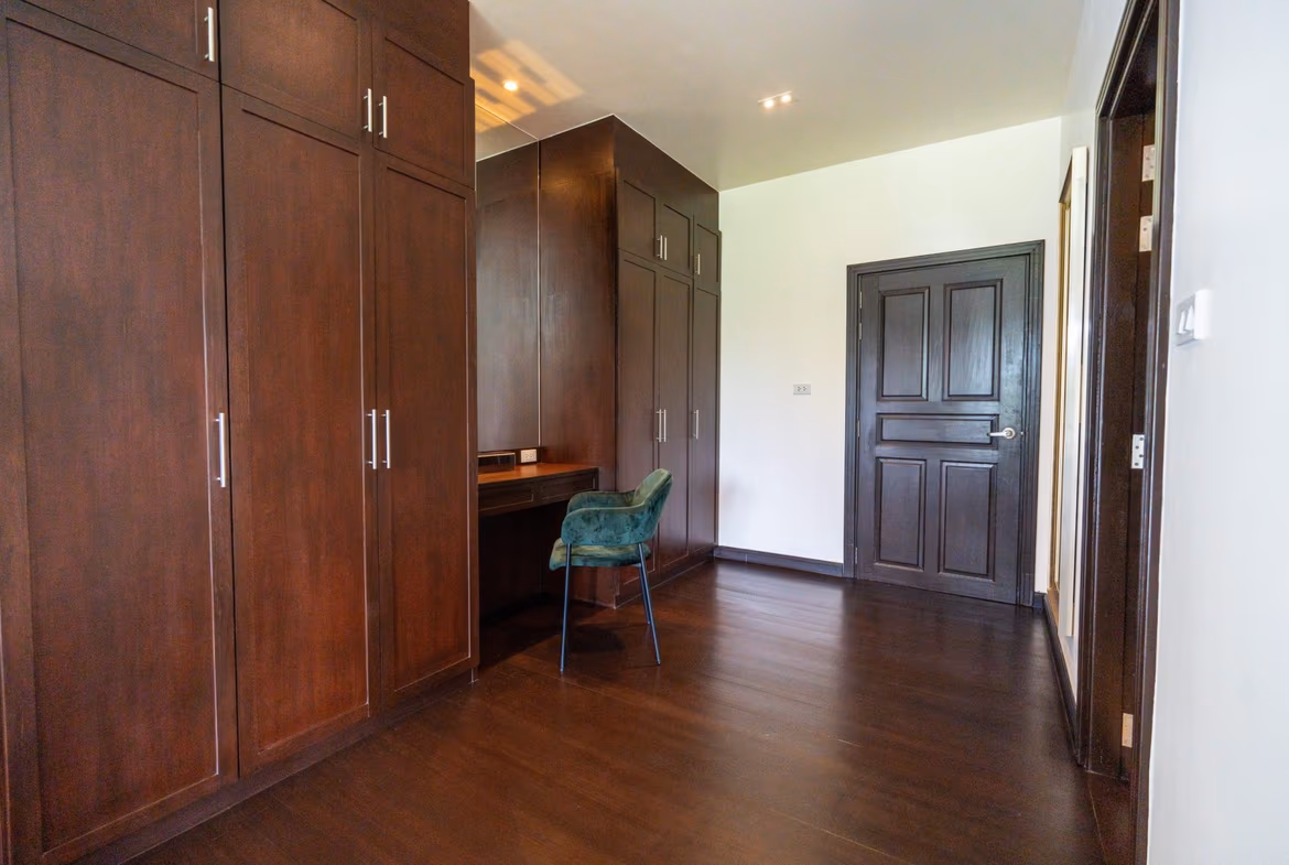 A master bedroom with a king-sized bed and two nightstands.