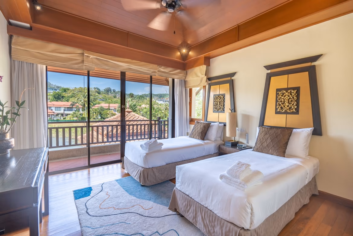 A spacious living area with modern furnishings and large windows.