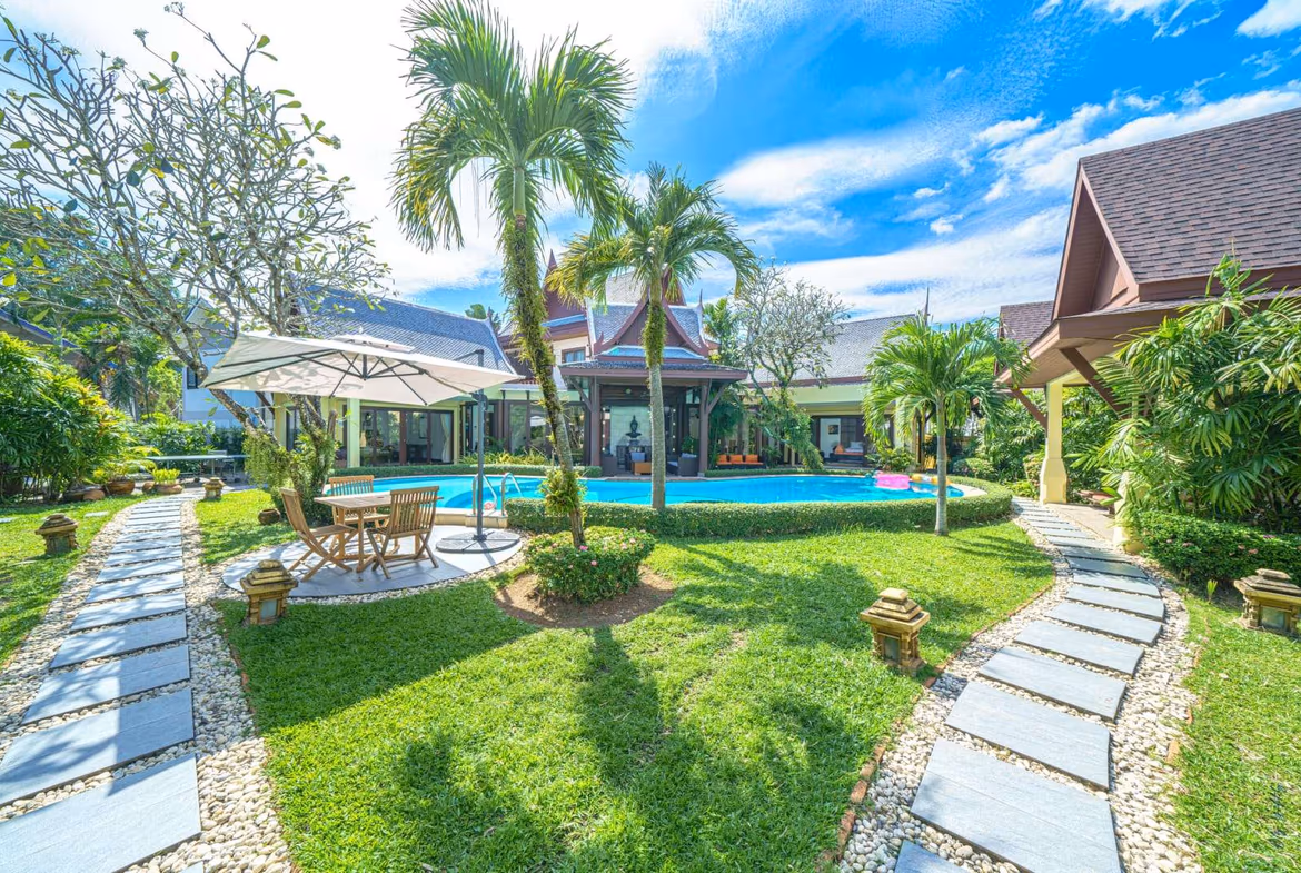 An 8-bedroom villa in Cherngtalay. The exterior shot shows a large building with a private pool in front.