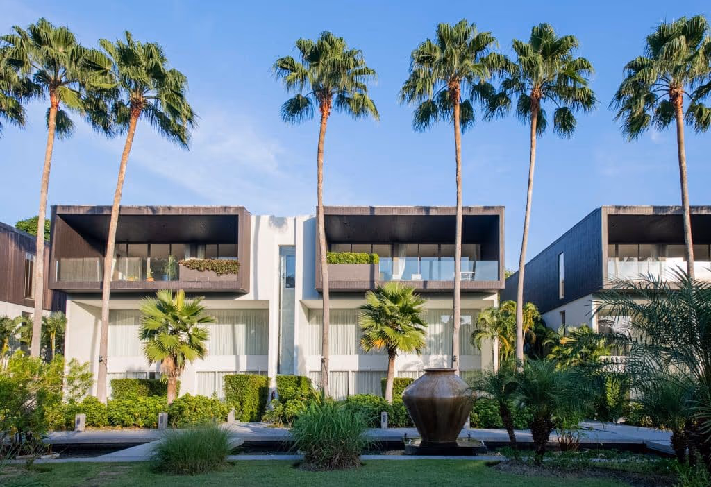 An exterior view of a two-bedroom apartment within a gated community in Cherngtalay, featuring a modern architectural style.