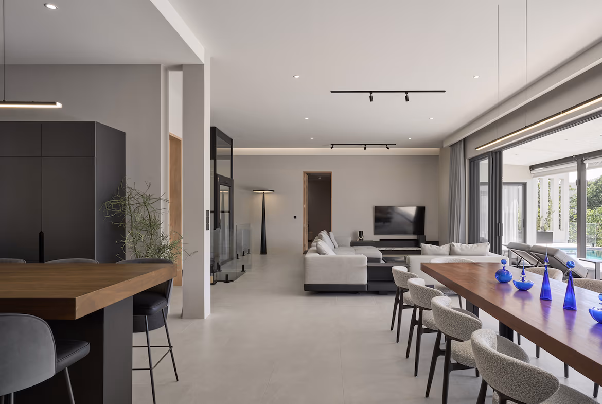 A modern, spacious living area with large windows offering mountain views.