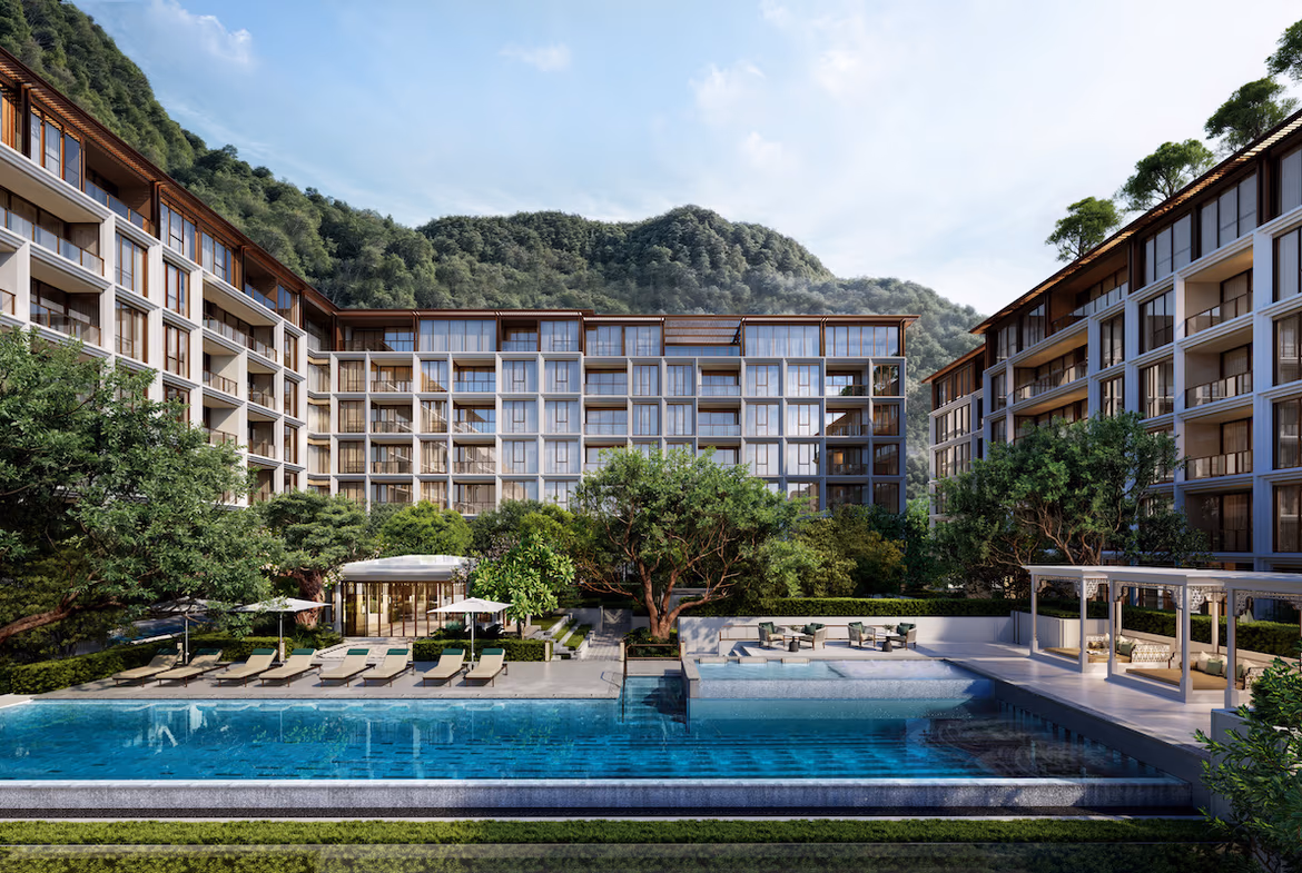 Exterior view of a 5-bedroom condominium in Cherngtalay, part of a gated community. The image shows the building's facade and surrounding landscape.
