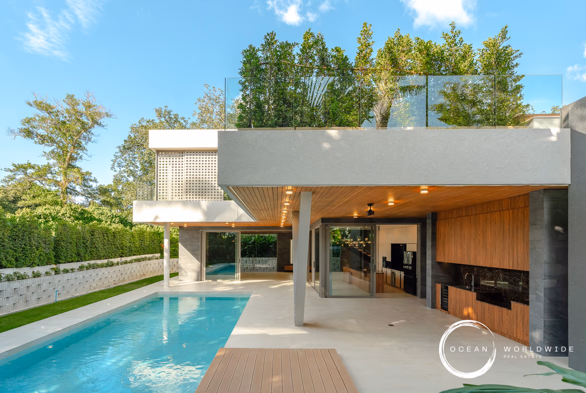 A modern 4-bedroom villa in Cherngtalay, featuring a large swimming pool in the foreground.
