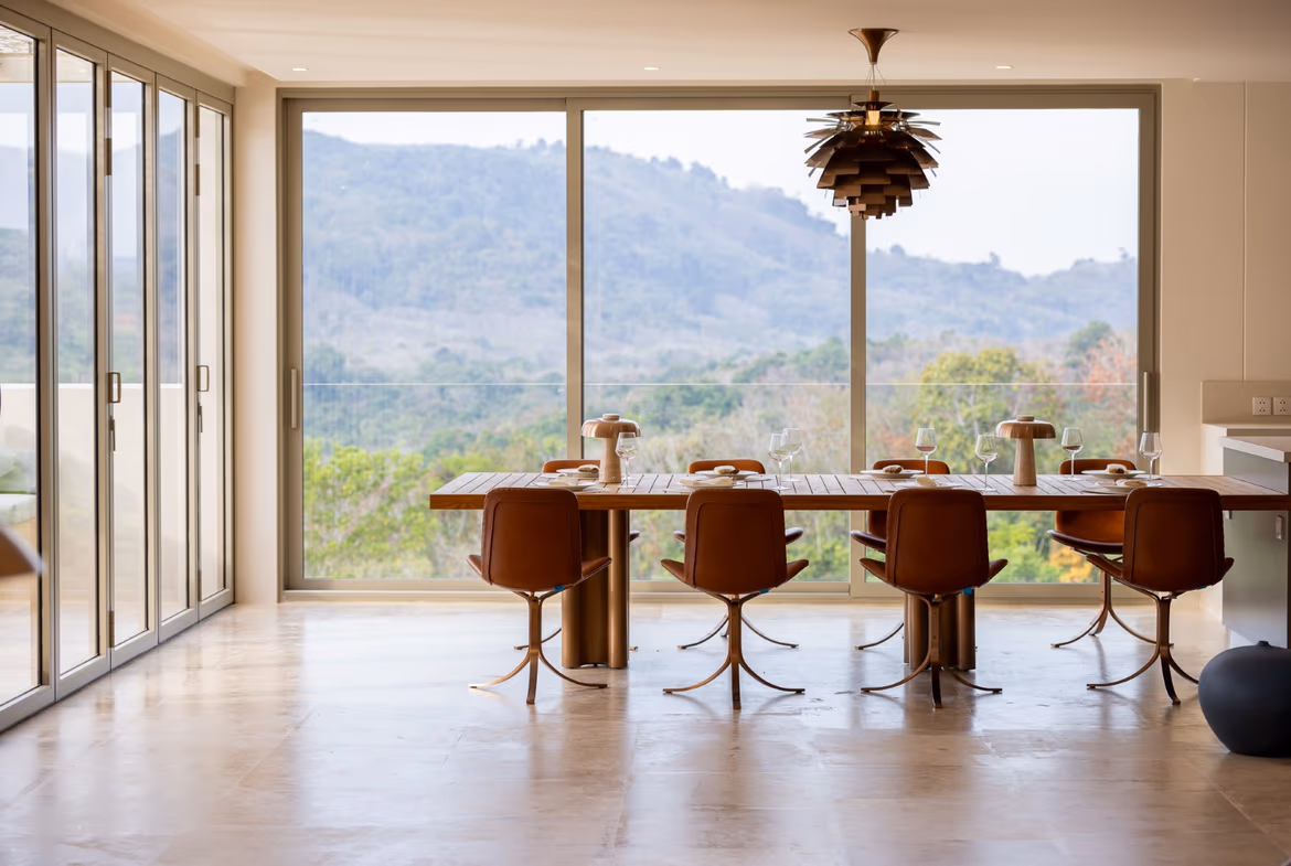 A spacious living room with large windows offers sea and valley views.