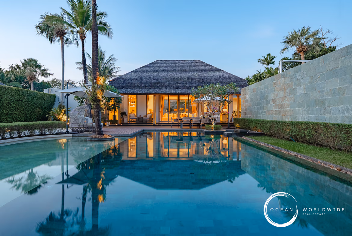 Exterior view of a 4-bedroom villa in Cherngtalay, featuring a large garden and a traditional Thai-style roof.