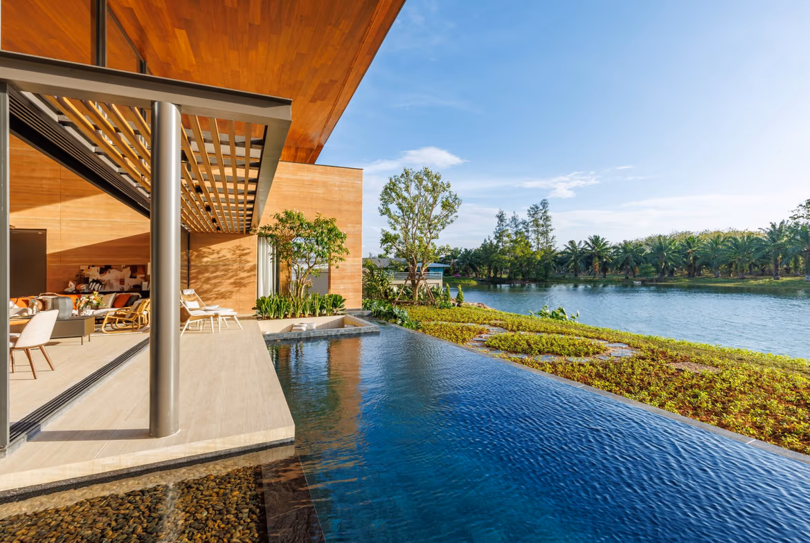 A modern swimming pool with a partial view of the lake in the background.