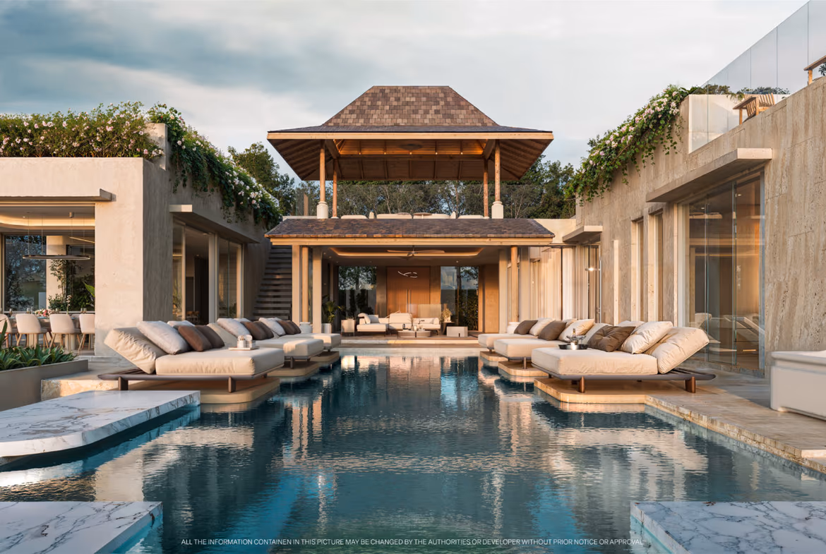 Luxurious resort pool area with beige daybeds along a central waterway and a wooden pavilion.
