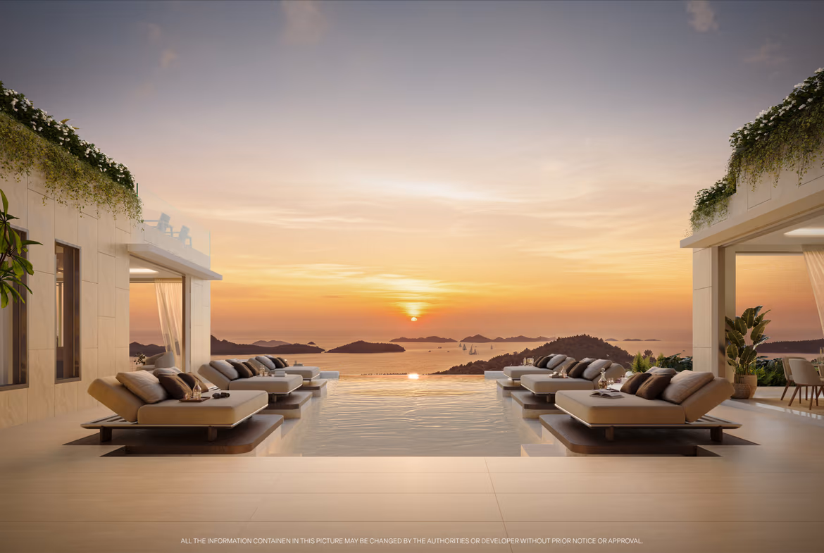 Sunset over the calm sea viewed from an infinity pool deck with lounge chairs at a modern resort